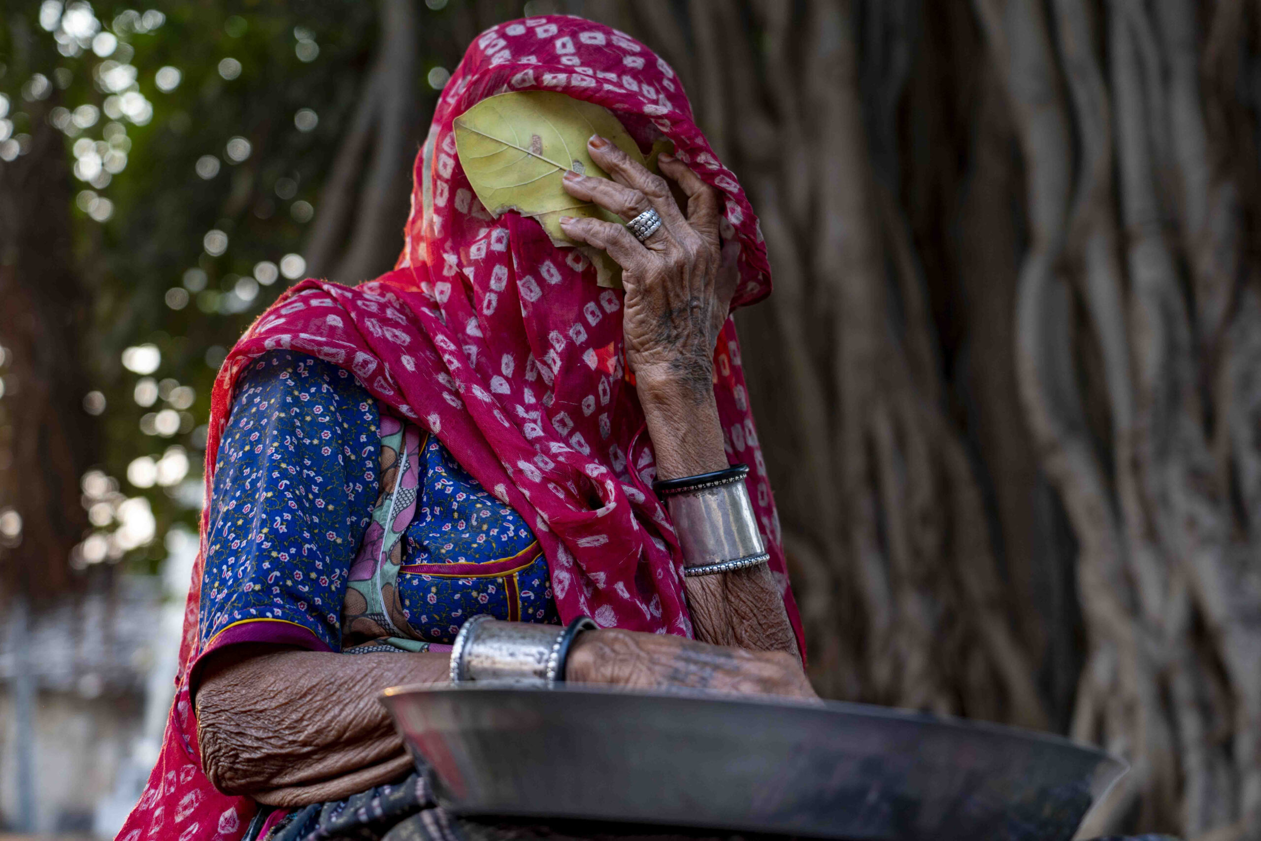 She Gave the Answer First — a woman holds a leaf before her face